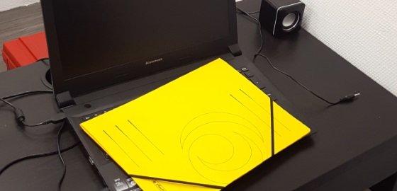 Gelbe Mappe auf Laptop auf schwarzem Schreibtisch